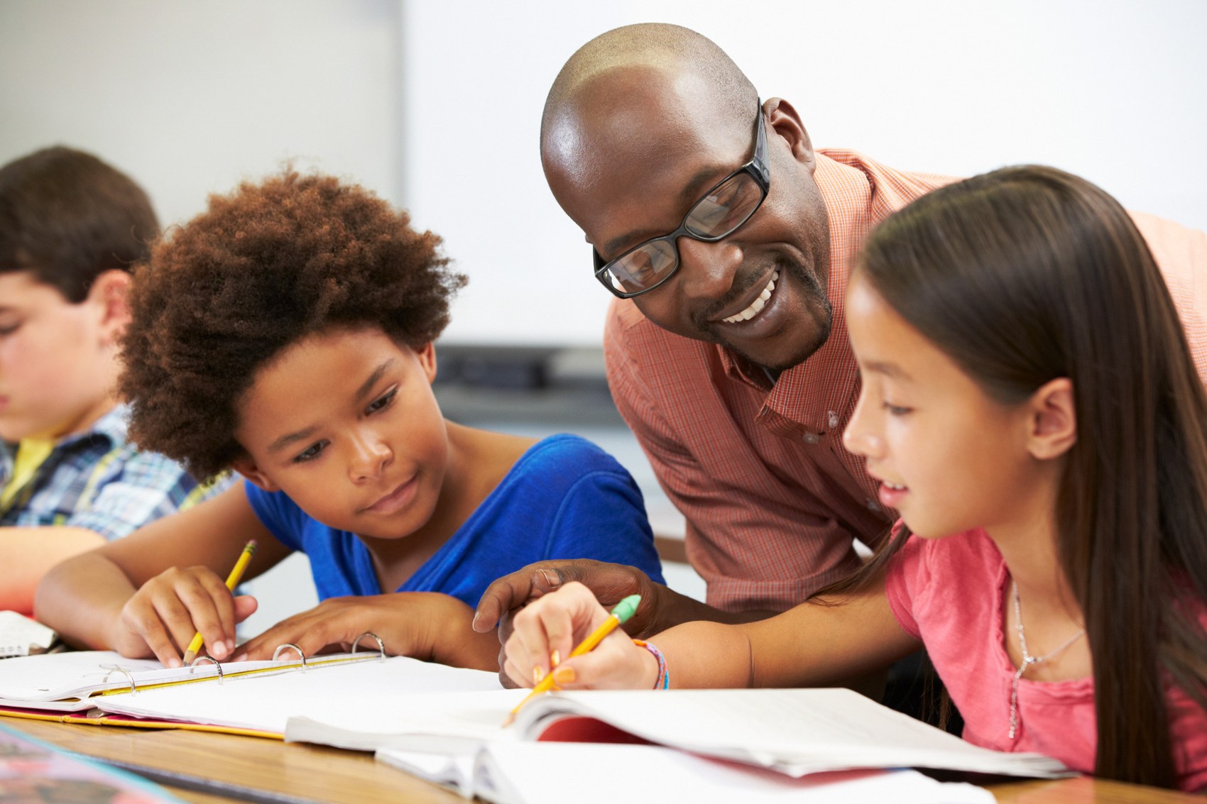 Teacher helping pupils with their work
