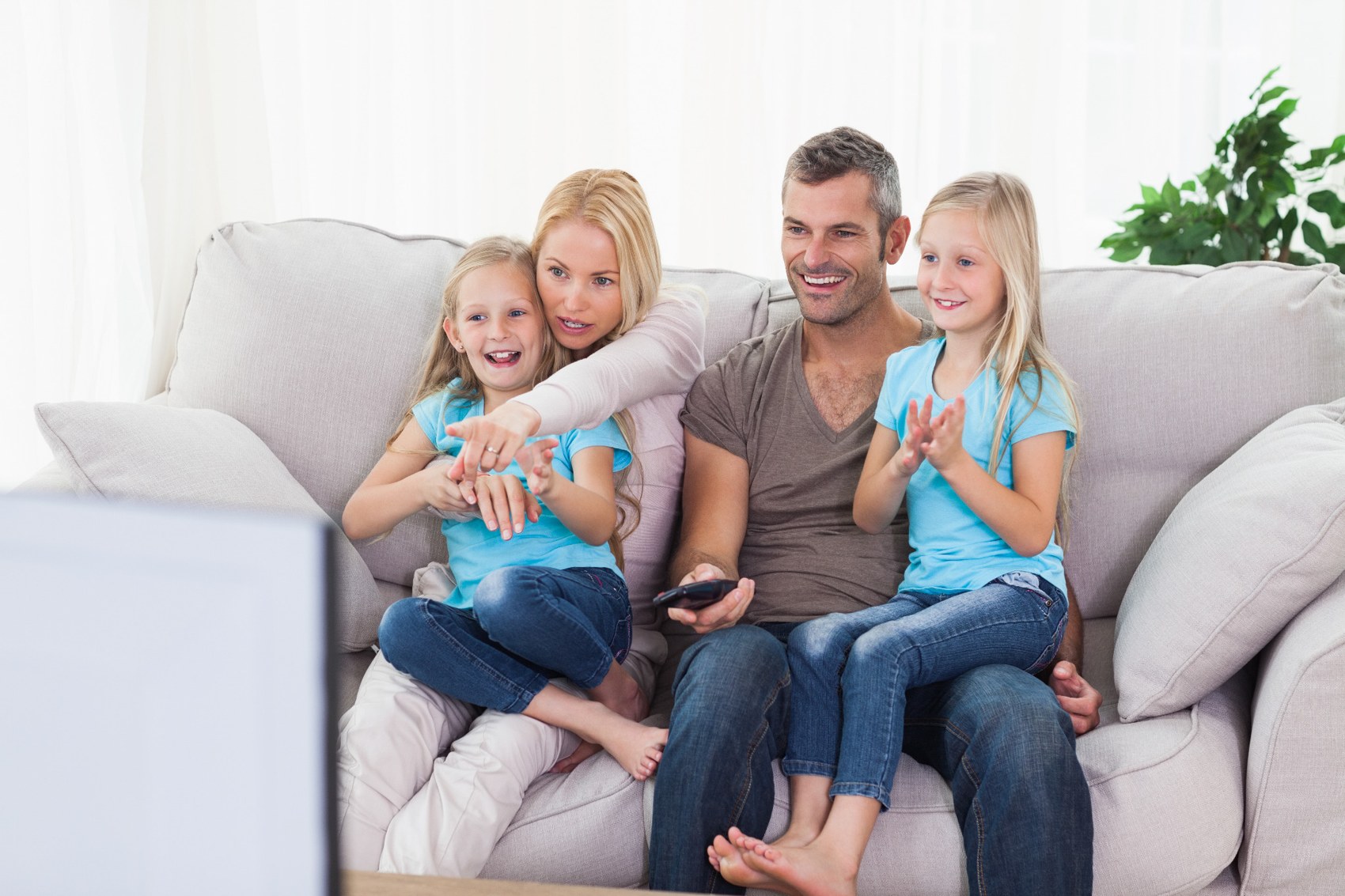 Family spending time together on a sofa